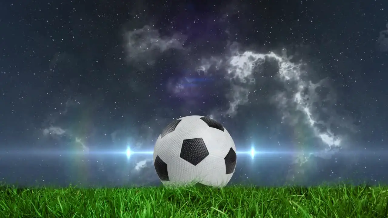 Animation of glowing light passing by football on pitch with stormy clouds