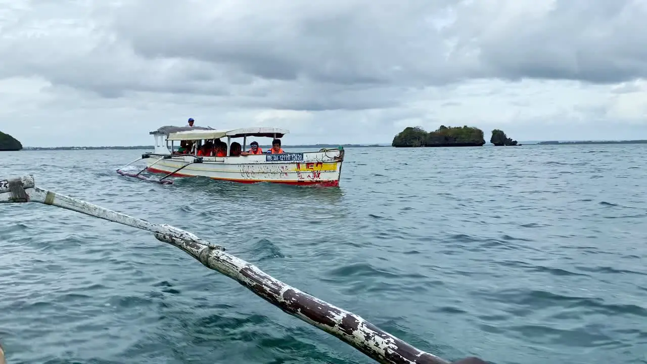 Bangka Boats Carrying Tourists Sailing by Islands in the Ocean Tourist Travel and Destinations