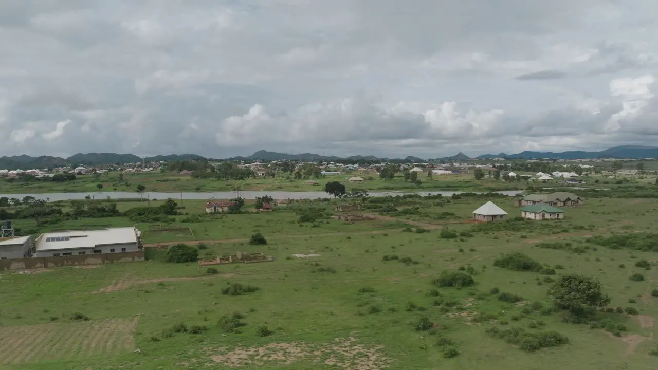 Aerial lake and rural Community spinning shot