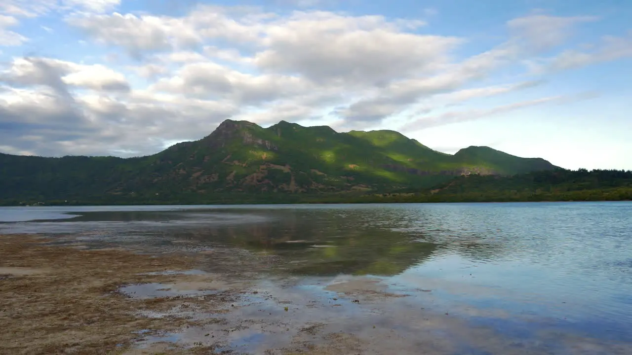 Waterside view of green forested hills