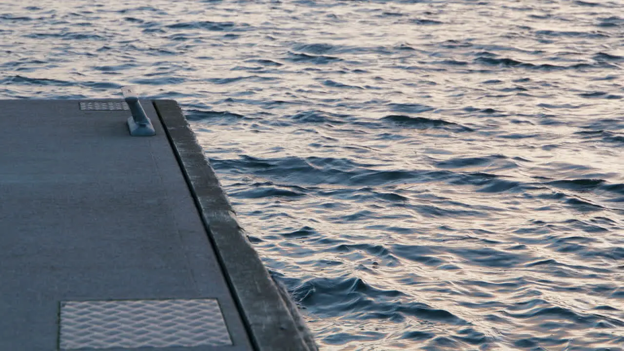 Concrete jetty and sea waves in the archipelago sunset in slow motion