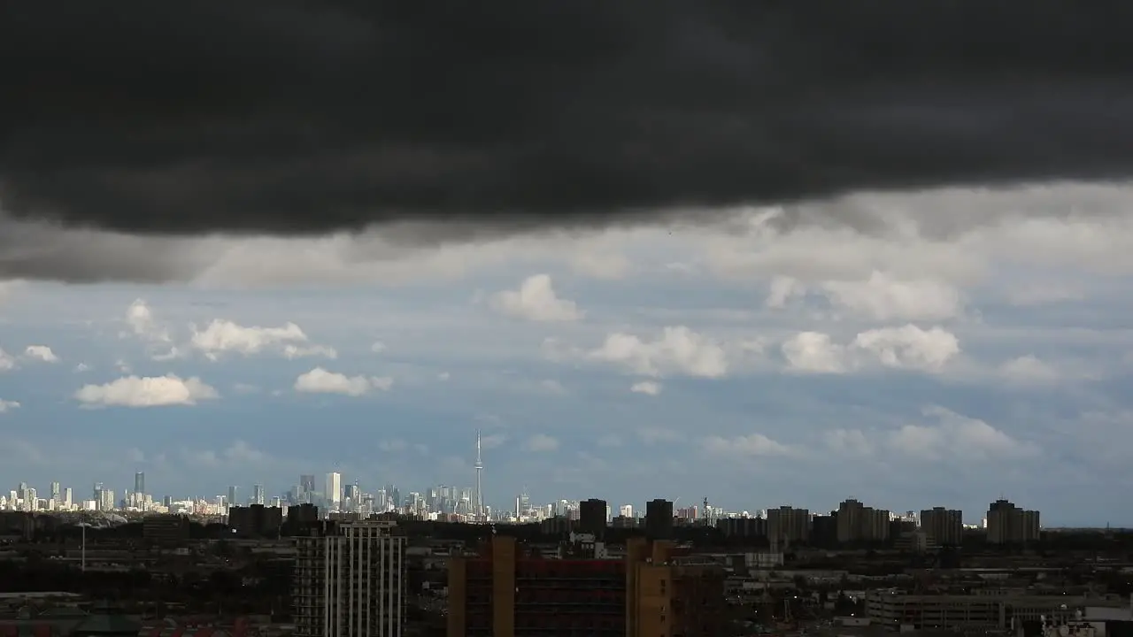 Stunning timelapse of dark turbulent clouds rolling over the skyline of Toronto Canada creating a dramatic and intense sky