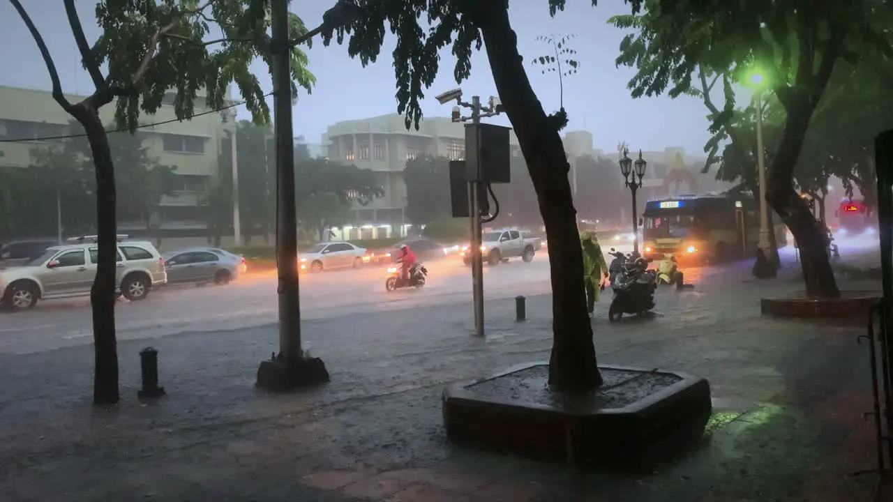 Sidewalk is being flooded in rainy monsoon season Bangkok next two a main road