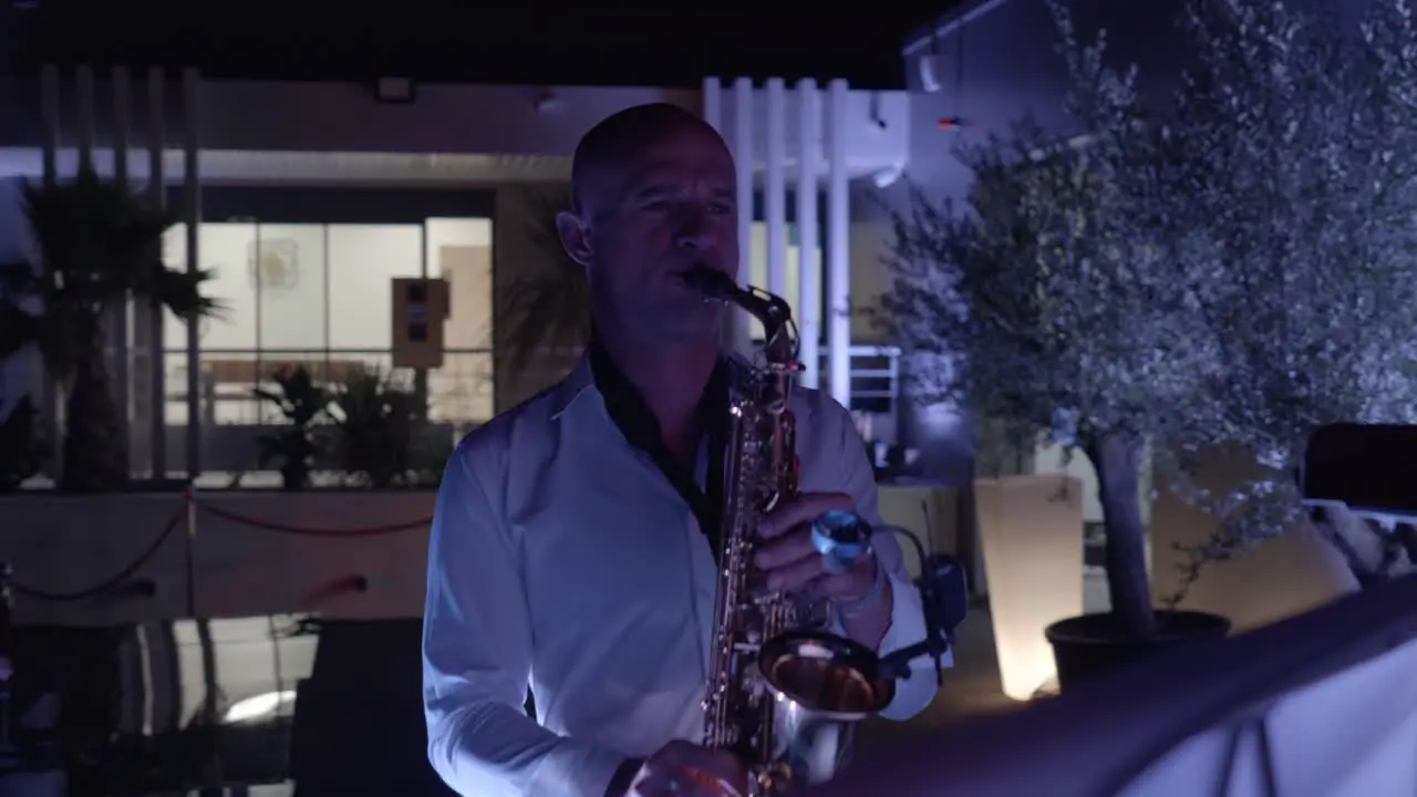 Close-up shot of a saxophonist playing music live to guests at an event