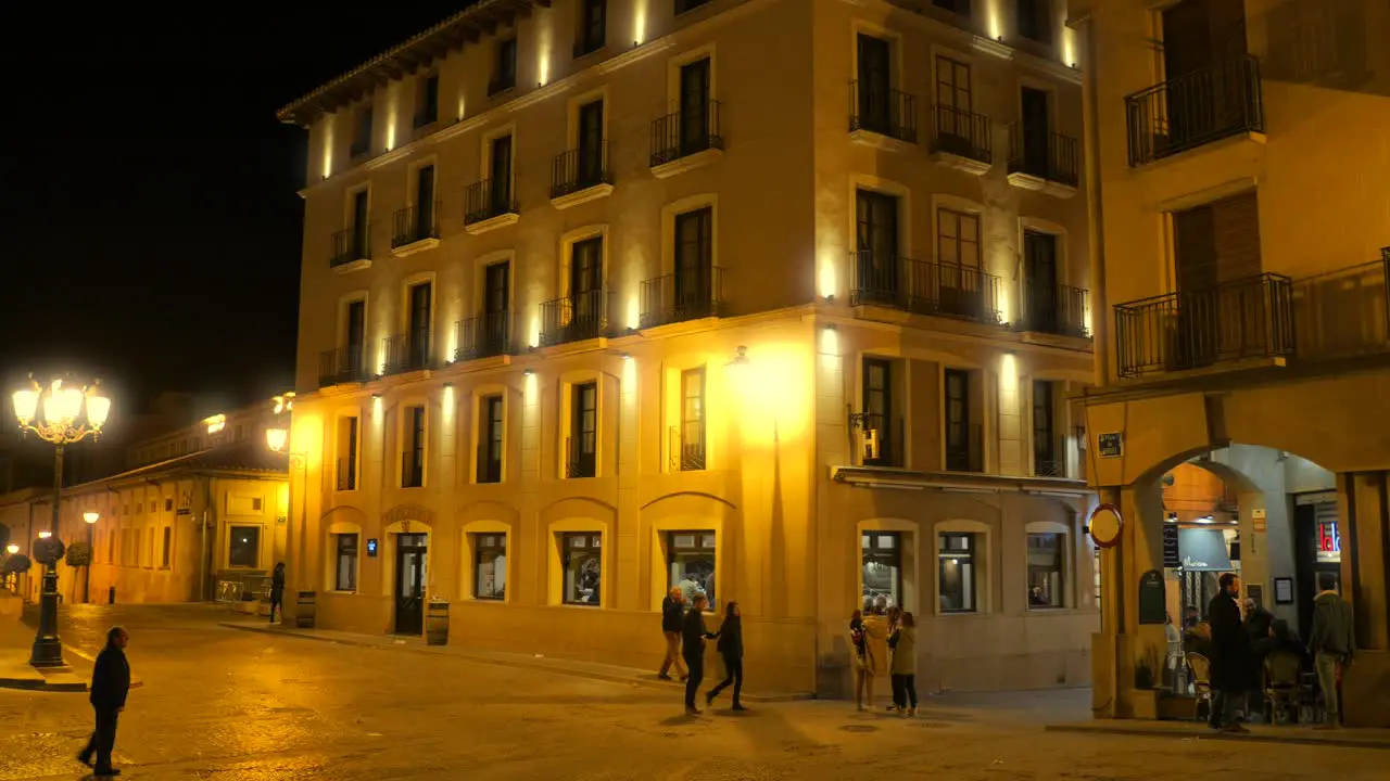 Main Square Of Historic Spanish Town Of Alcañiz With Tourists At Night wide