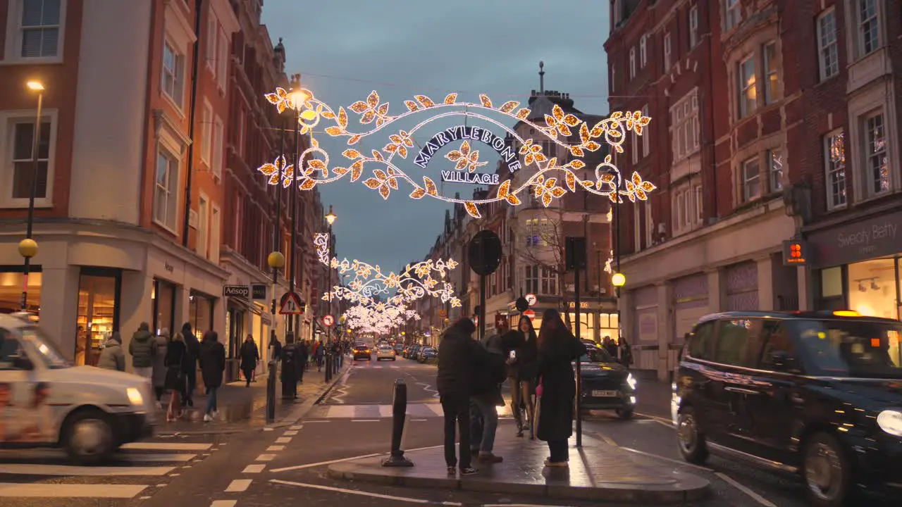 Cars And Pedestrians In The Street At Night With Christmas Decor In Marylebone London England