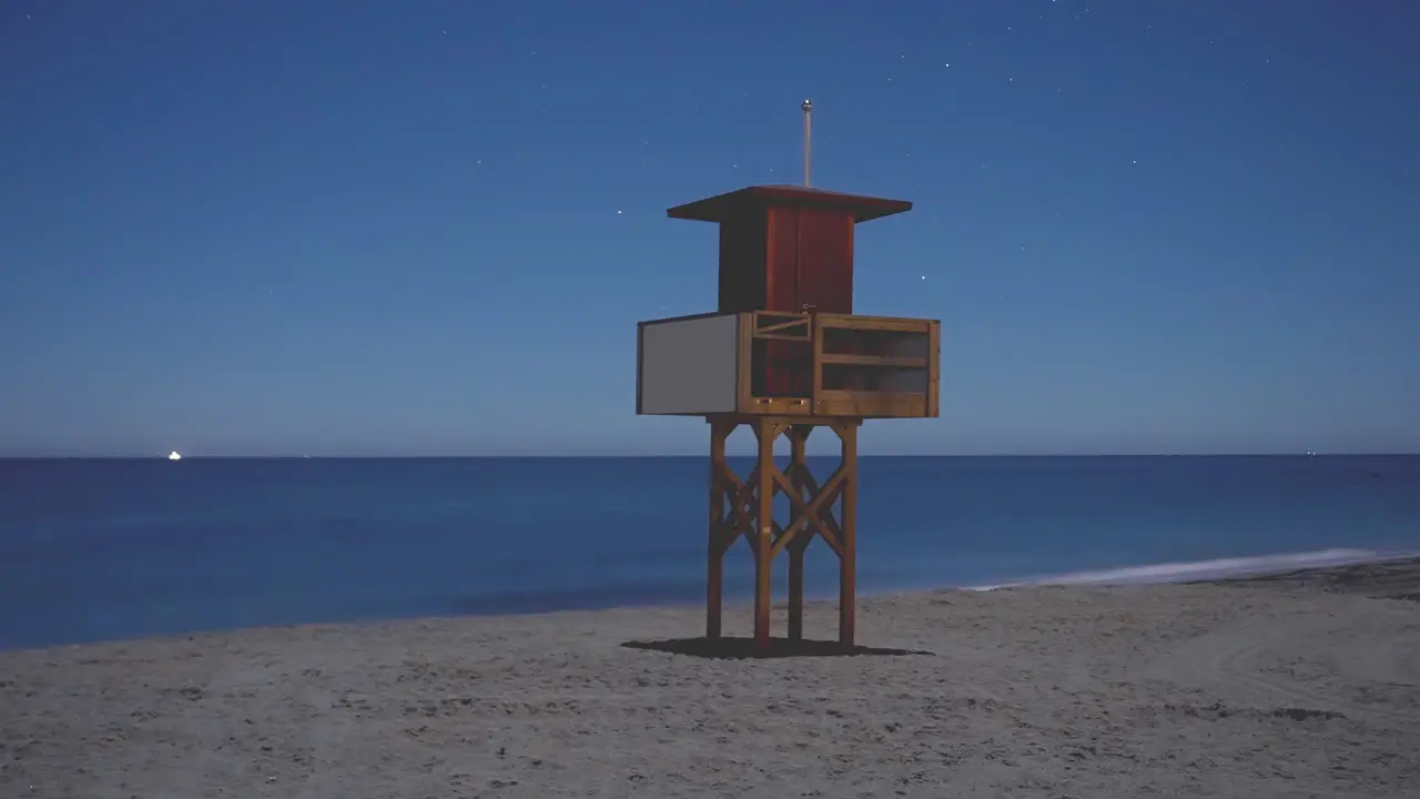 Small lifeguard tower at night time lapse on the Mediterranean coast