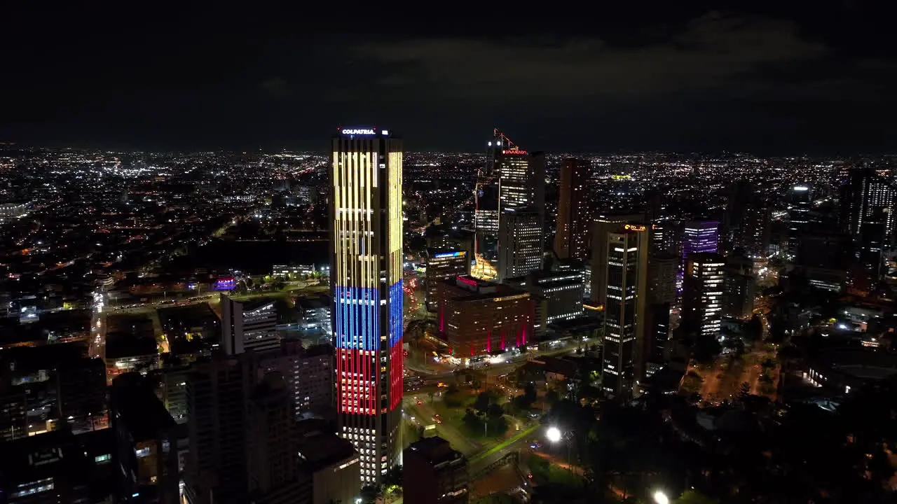 Aerial view circling illuminated skyscrapers in downtown Bogota night in Colombia