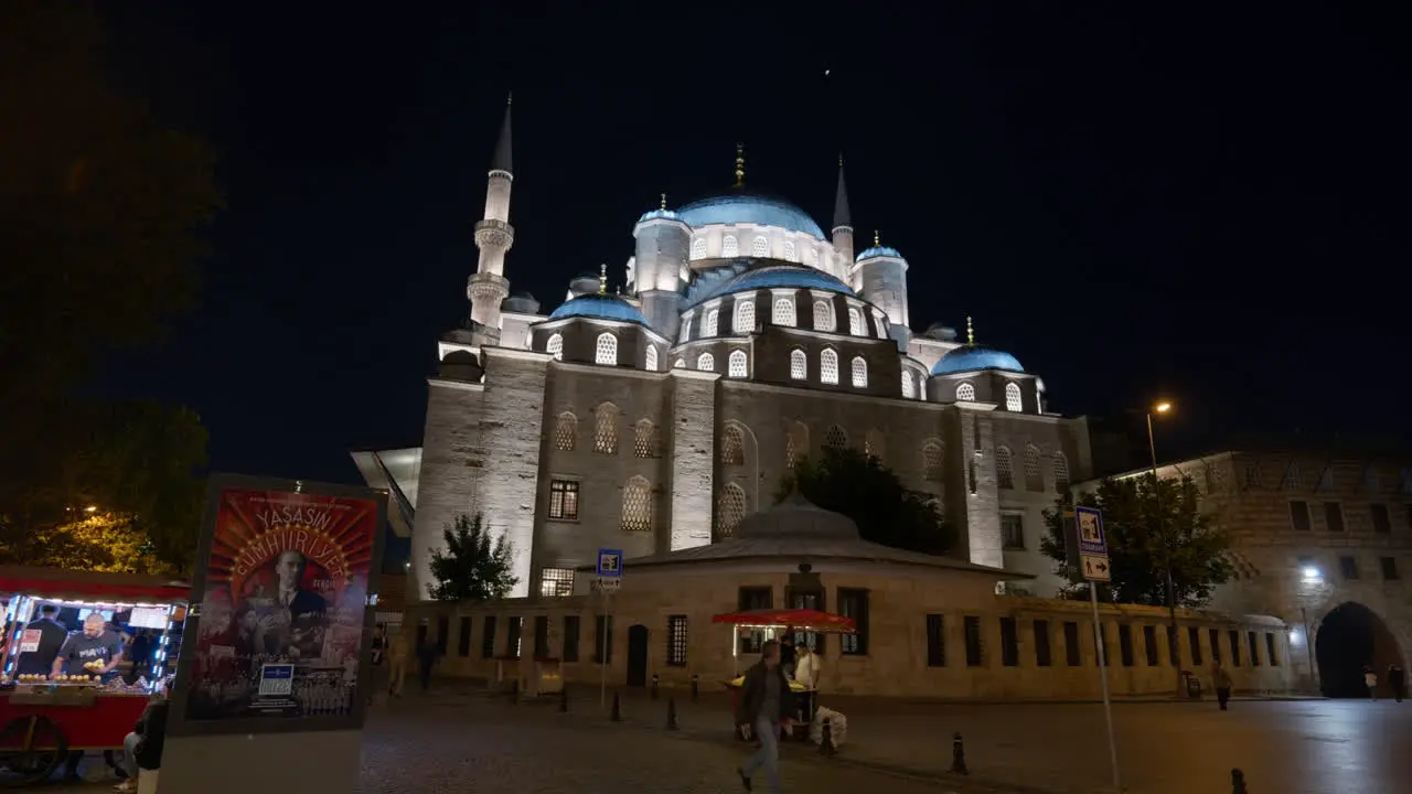 Street vendors at illuminated new mosque Eminonu Istanbul Yeni Camii