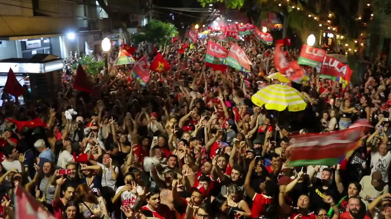 Crowds fill the streets chanting and waving flags in celebration of the election of President Lula in Brazil