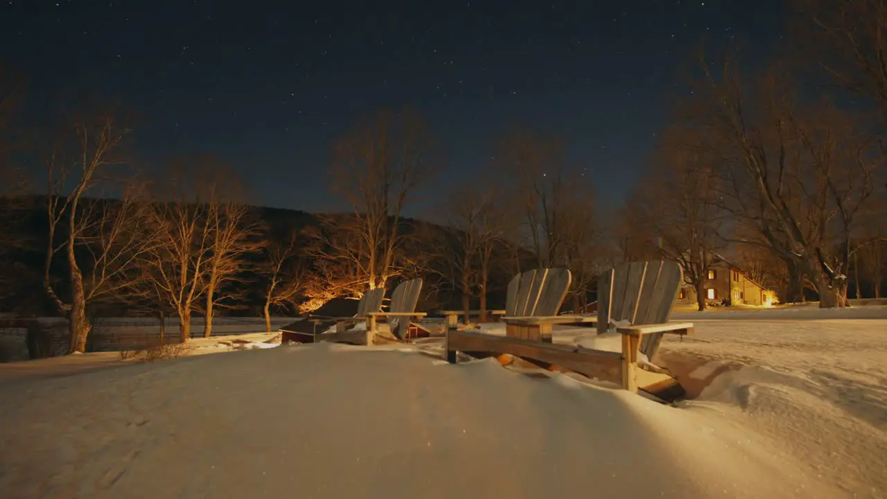 Time Lapse of Stars Over Scenic Chairs Sitting in Snow