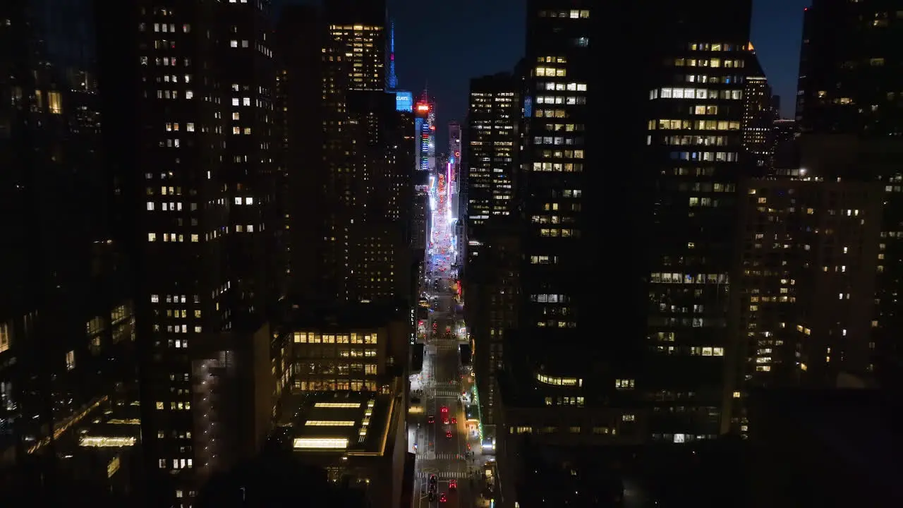 Aerial view backwards through the 7th avenue away from the Times square night in NY USA