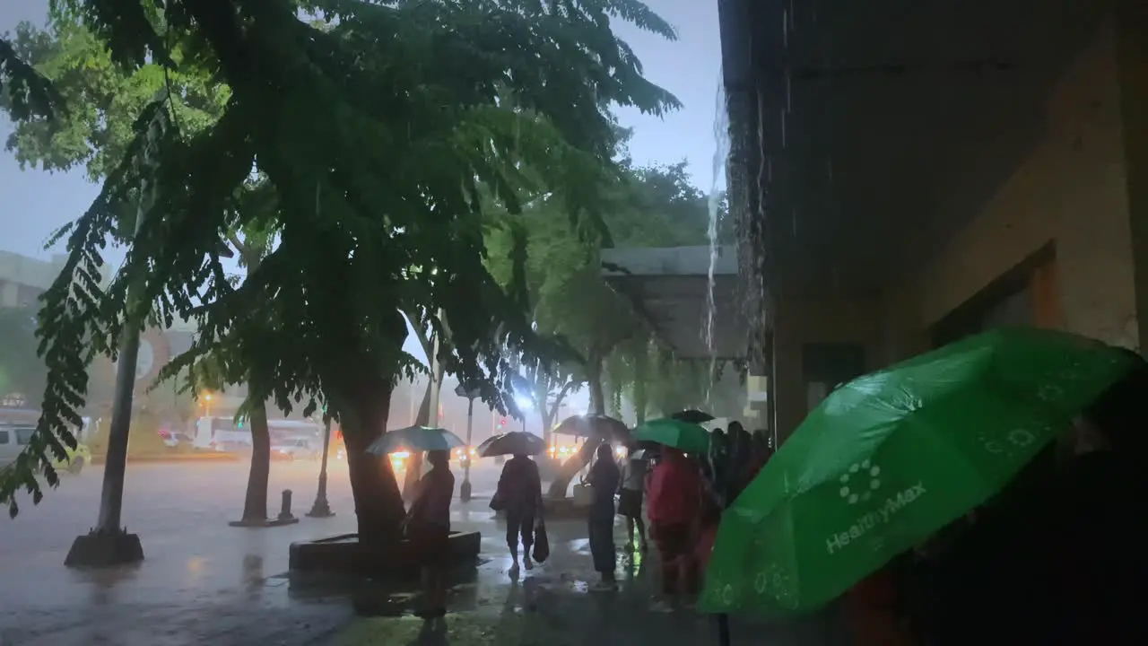 People waiting for rain to stop in Bangkok Thailand Monsoon season