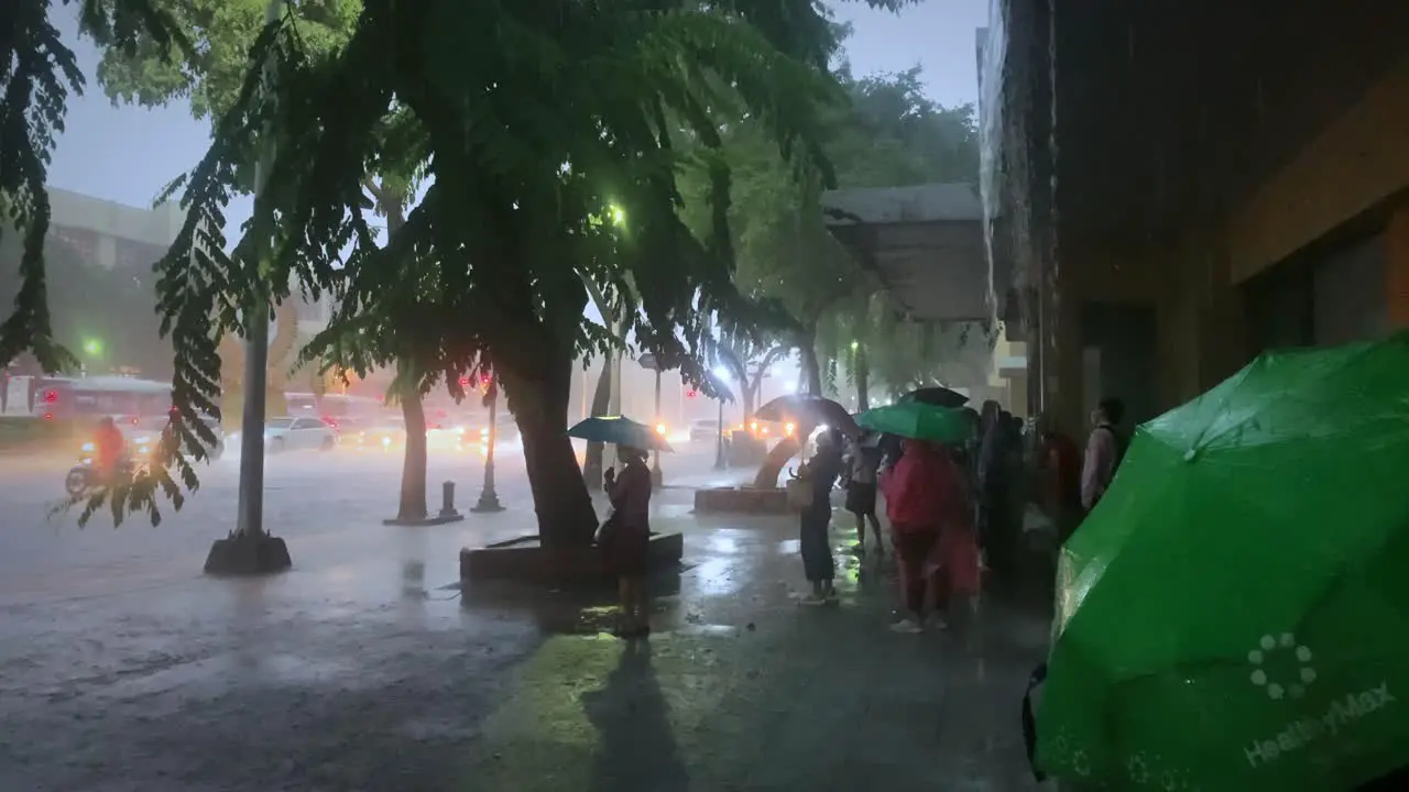 Thai People waiting for rain to stop in Bangkok Thailand Monsoon season 4k