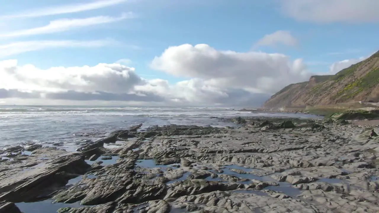 Low drone shot over scenic ocean rocks