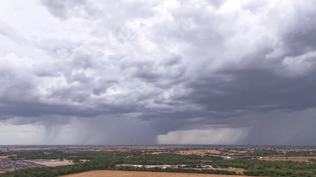 Overlooking the countryside rain moving across sky with two distinct columns of precipitation falling onto the landscape