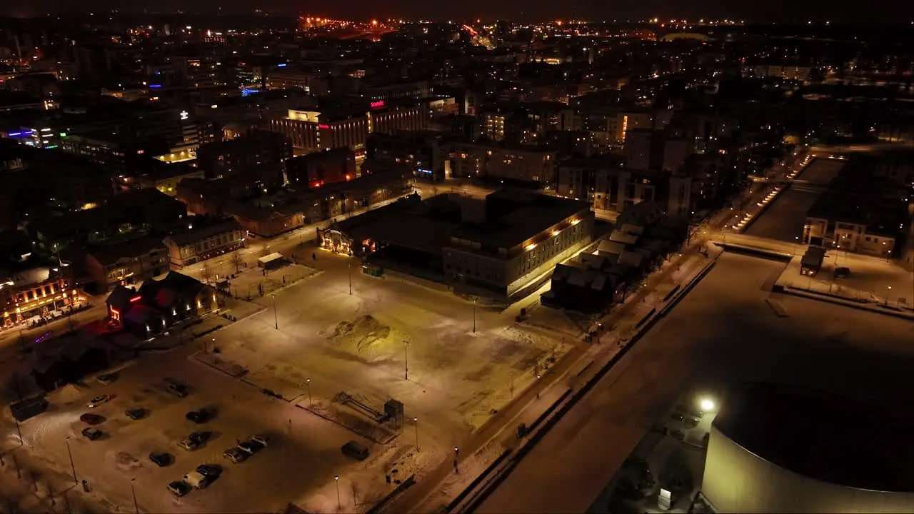 Aerial view around the night lit Kauppatori market hall winter in Oulu Finland