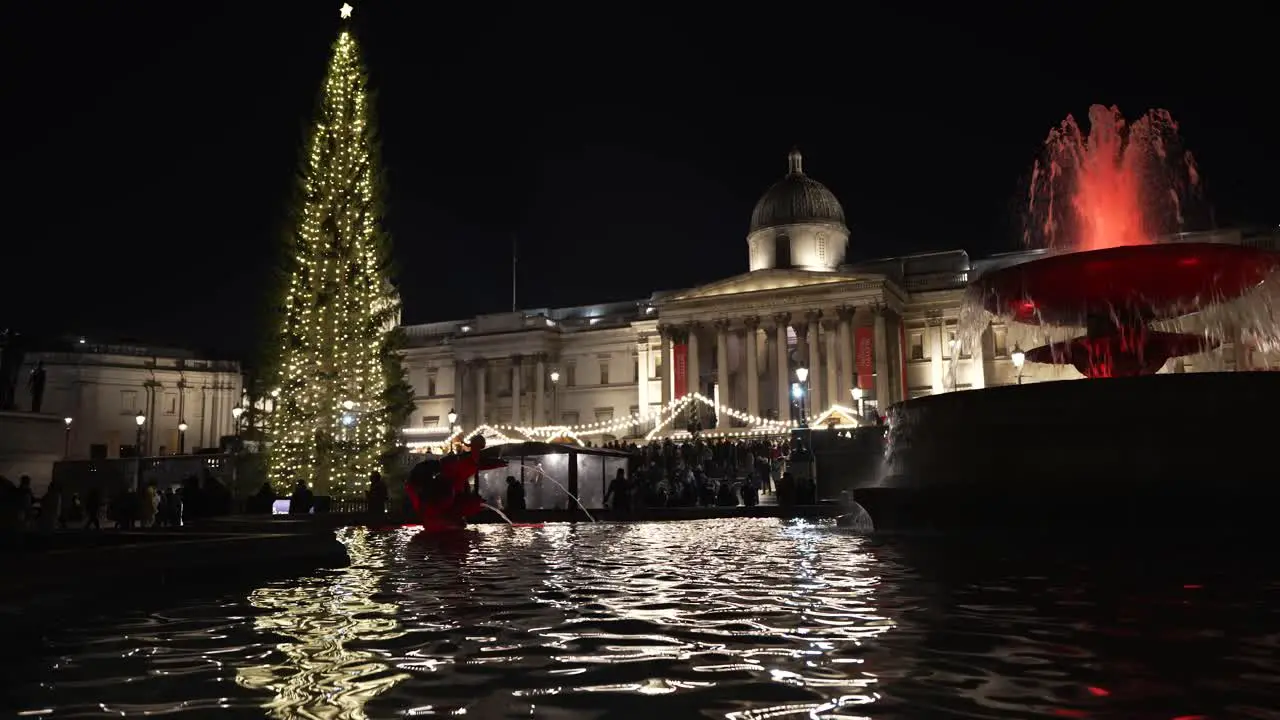 Trafalgar Square Christmas Tree Market Lights Reflected In Fountains