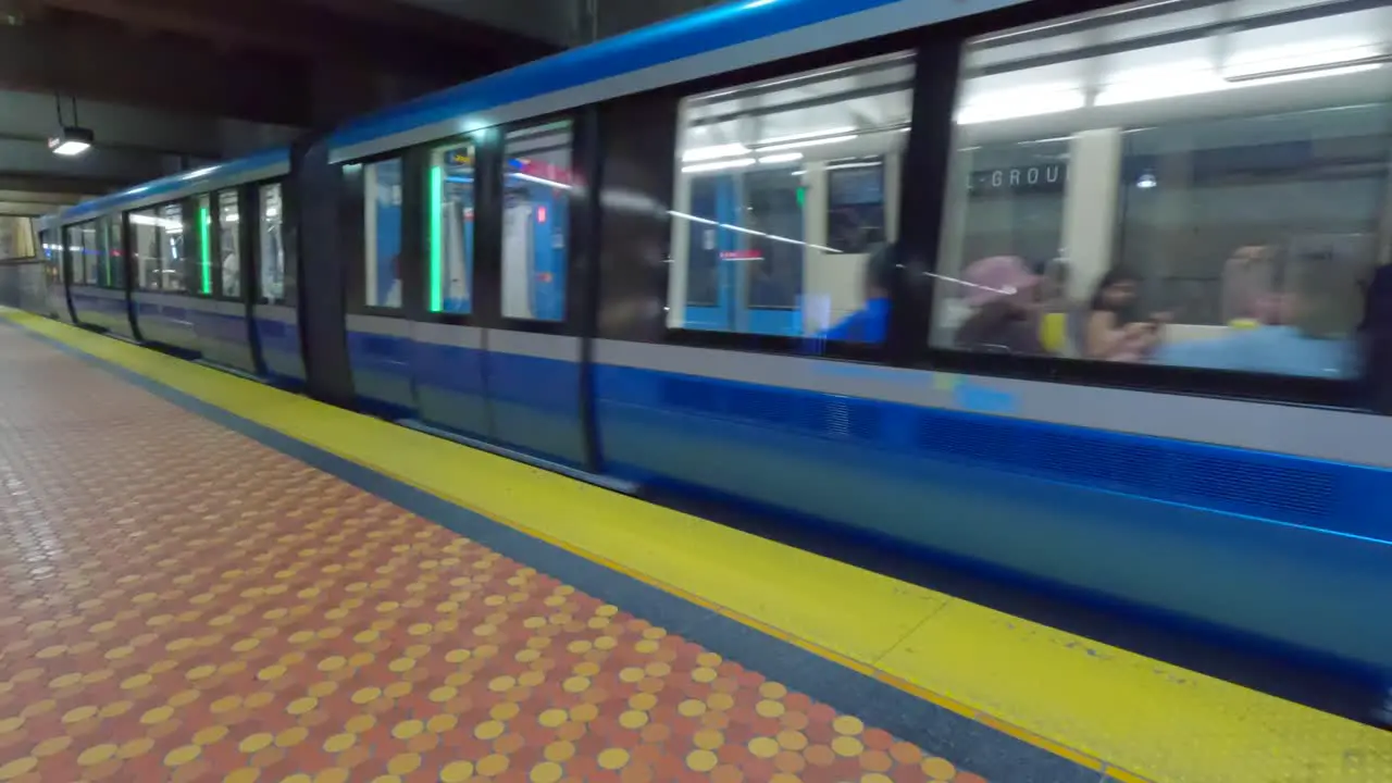 Pan Left Shot as a Montreal Metro Train Arrives at Lionel Groulx Station in Montreal Quebec