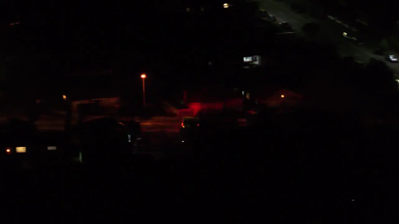 Night time aerial view of emergency vehicle operating in the city