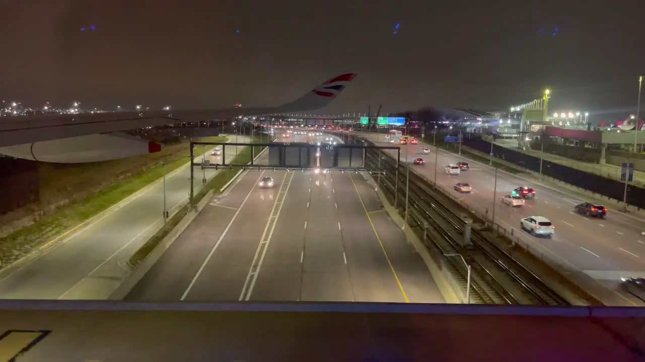 Night airplane taxi over a highway bridge 30fps 4k