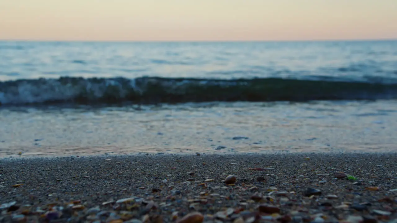 Closeup sea water waves splashing sandy beach evening Sand beach macro