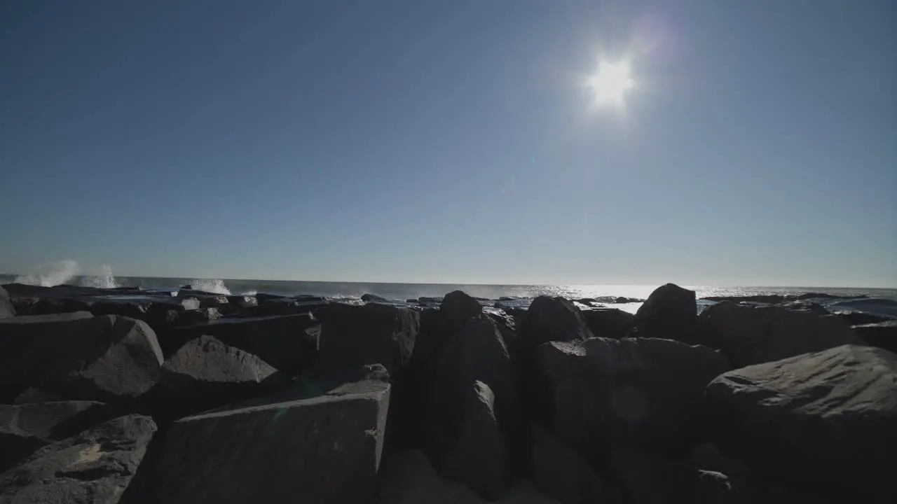 Waves crashing against a beach jetty