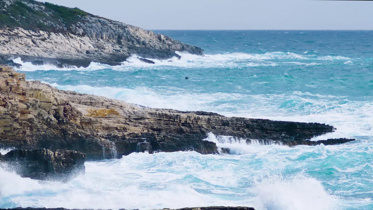 Big sea waves crushing on rocky shore restless sea on stormy and windy weather