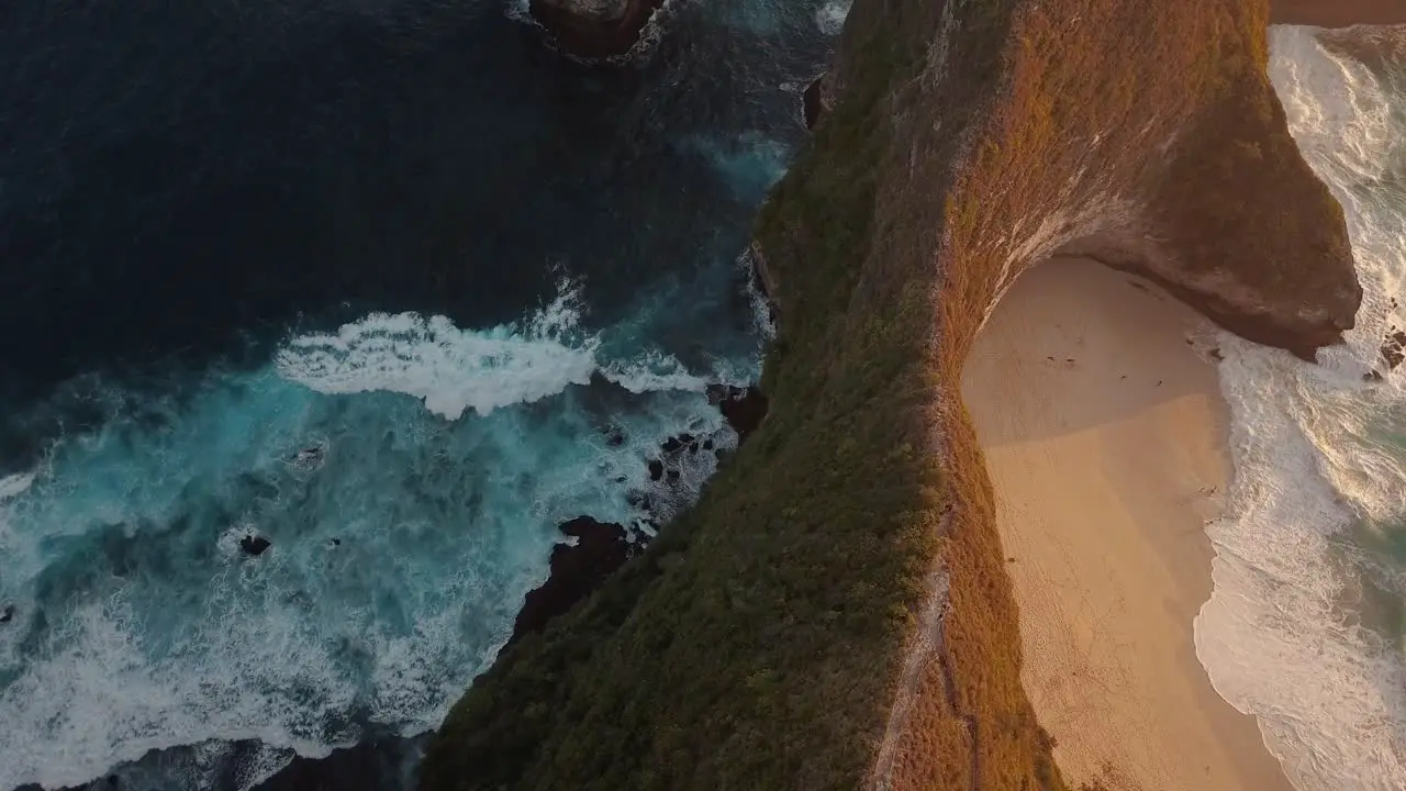 drone shot flying over the beach of crystal bay at sunset with the camera facing down Nusa Penida Indonesia in 4k