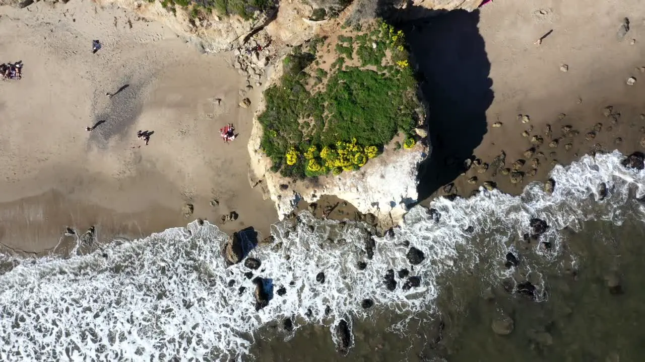 Drone shot of El Matador Beach in Malibu California showing the ocean white water waves and beach from above