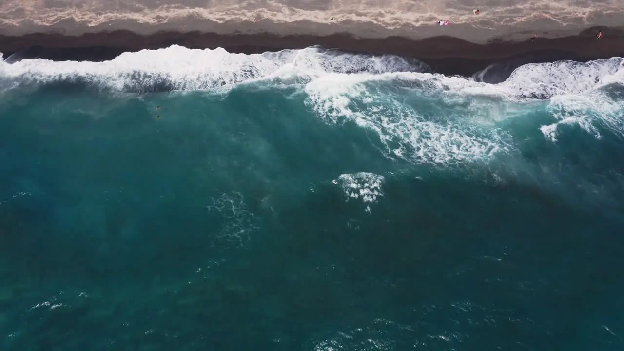 Aerial backwards reveal shot of Vlychada beach in Santorini Greece 4K prores