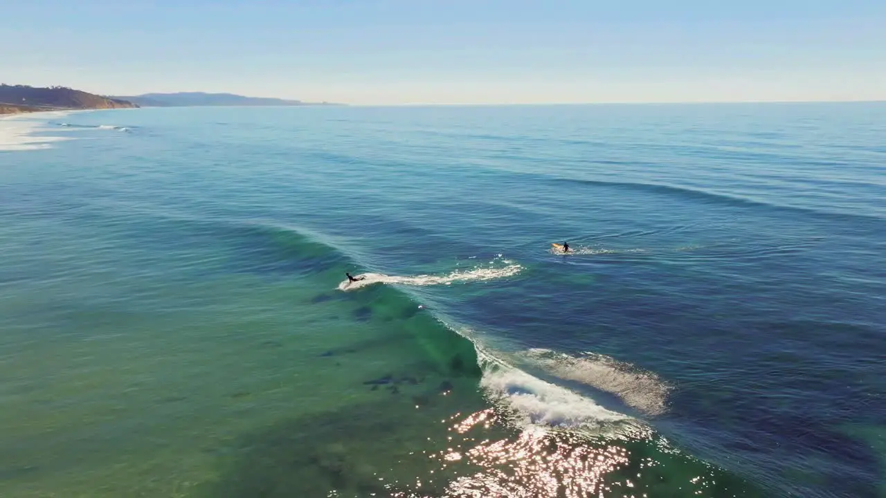 Surfer Surfing Ocean Waves In San Diego USA drone shot