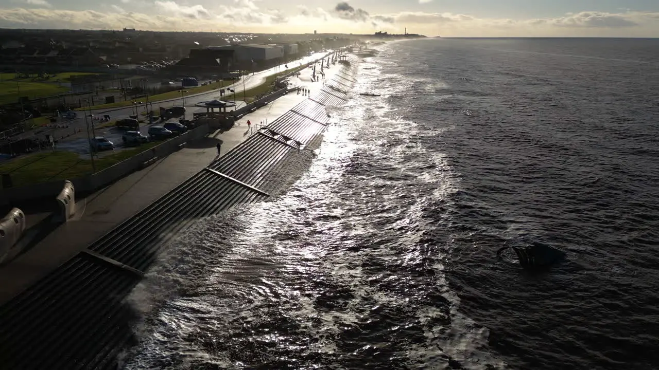 Slow motion waves crashing against sea defences on bright day in winter at Cleveleys