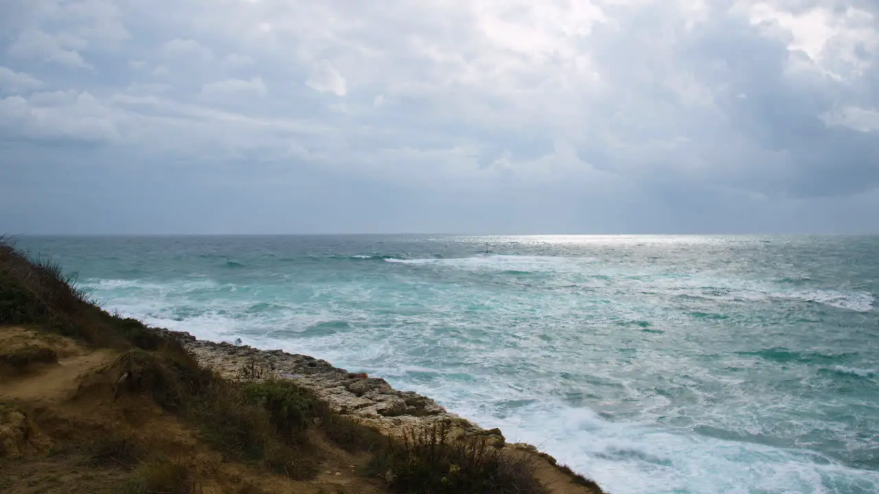 Rocky coast on stormy weather big waves breaking on shore restless sea