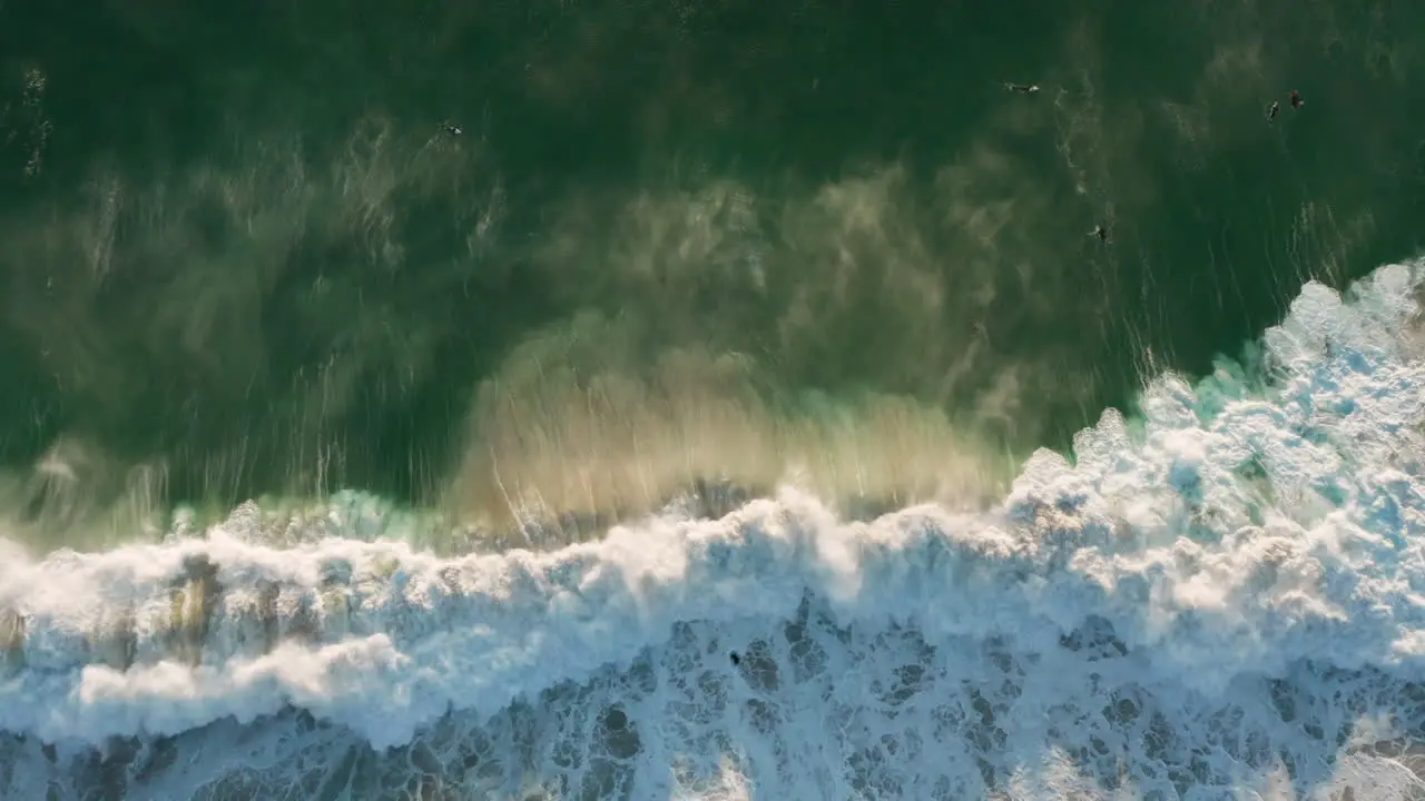 Beautiful drone shot showing a big wave breaking with sunset in Llandudno Cape Town