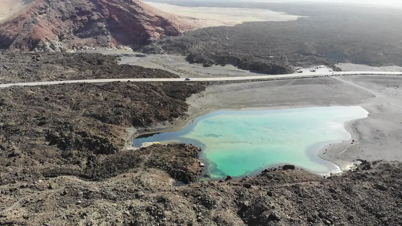 rotation over a small lake in Lanzarote revealing the volcanos land behind