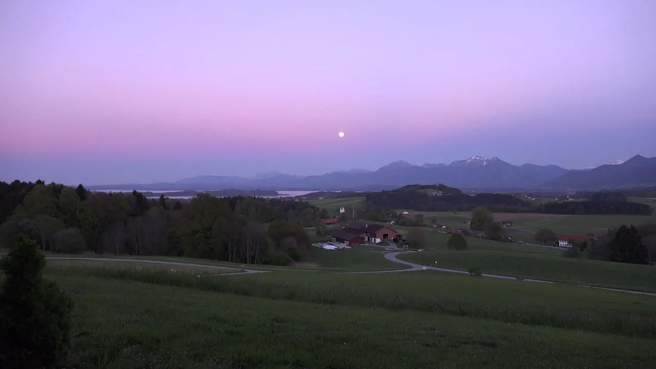 Germany zoom in to full moon over village