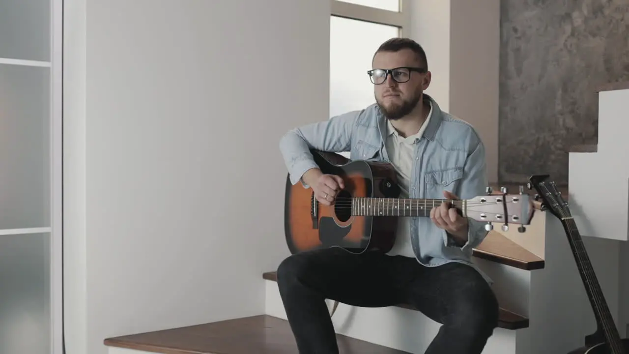 Male Musician Playing Guitar At Home