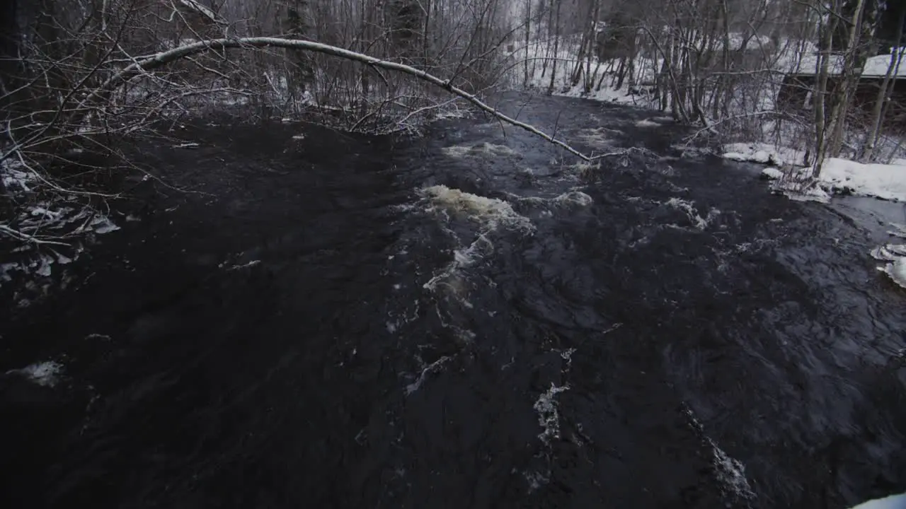 Winter dark blue river in slow motion with waves and foam