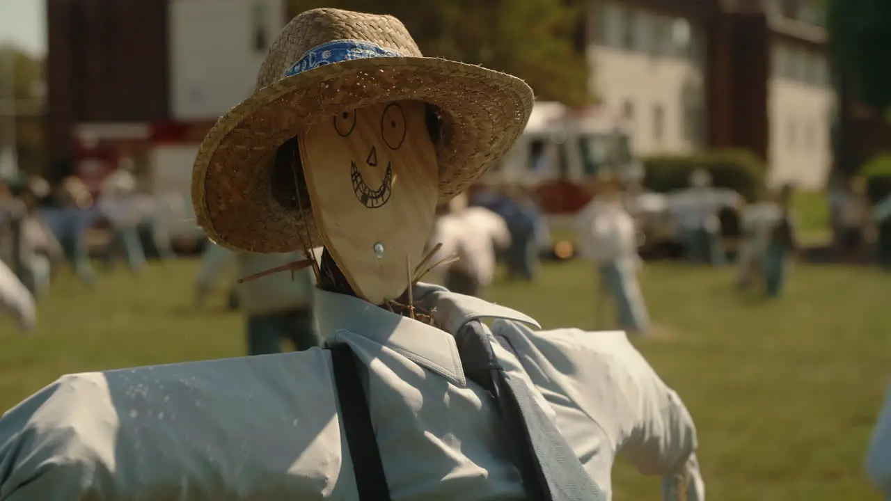 Wooden scarecrow in large field with others Slow Motion