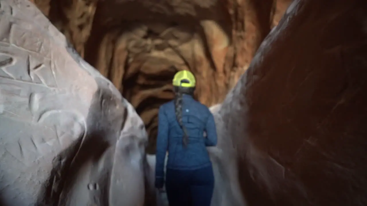 Back of Woman Walking in Belly of the Dragon Tunnel Hiking Train in Utah USA