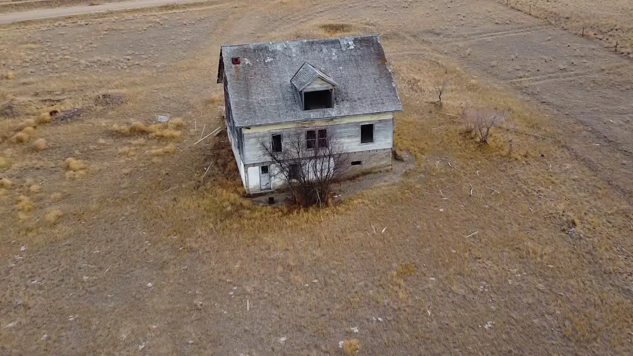 Aerial view of an old torn-up abandoned house in the country near Empress Alberta Canada during the day