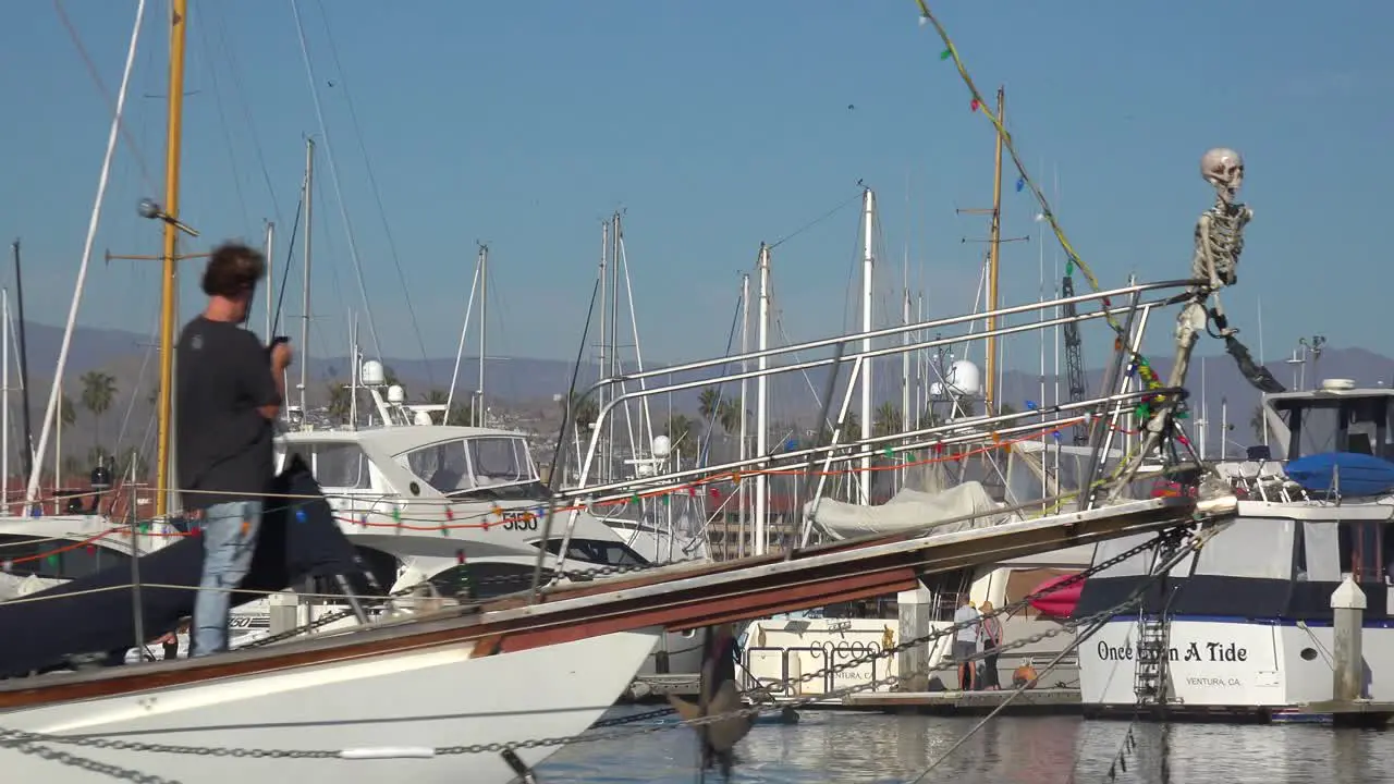 A Halloween Party Boat With A Skeleton On The Bow And Large Orange Pumpkin On Stern Moves Through Ventura Harbor California