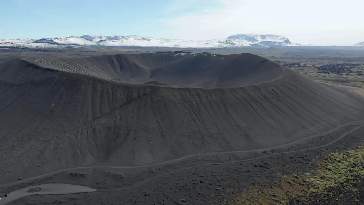 Aerial pan shot of the black Hverfell vulcano in Iceland near Myvatn