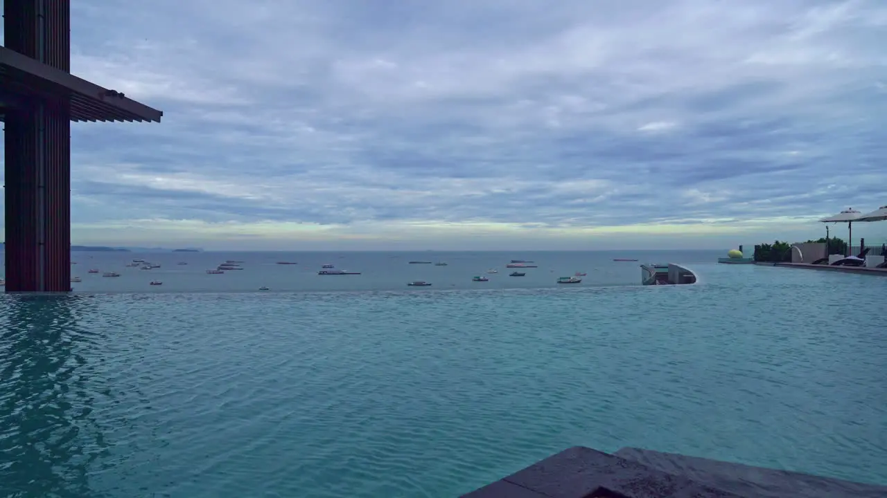 swimming pool with ocean sea and boat and cloudy sky background