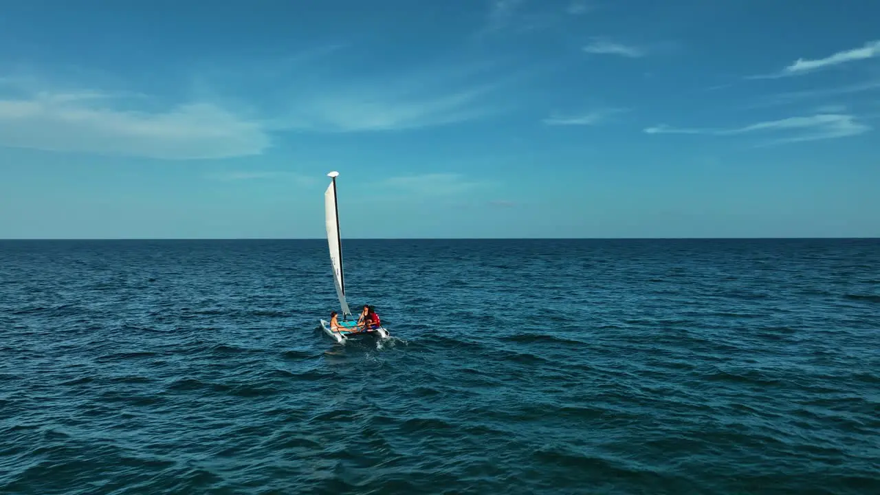 Aerial view around tourists sailing on the coast of Xpu Ha Mexico circling drone shot