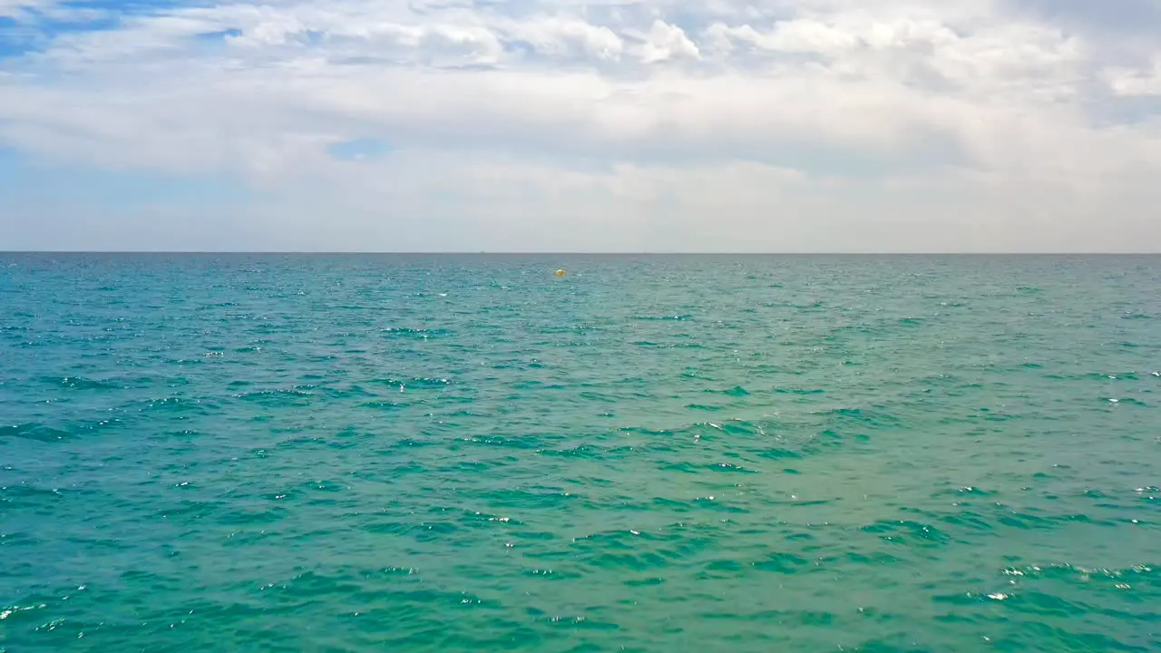 Scenic seascape view with cloudy blue sky and wavy agitated water Boat POV 4k shot