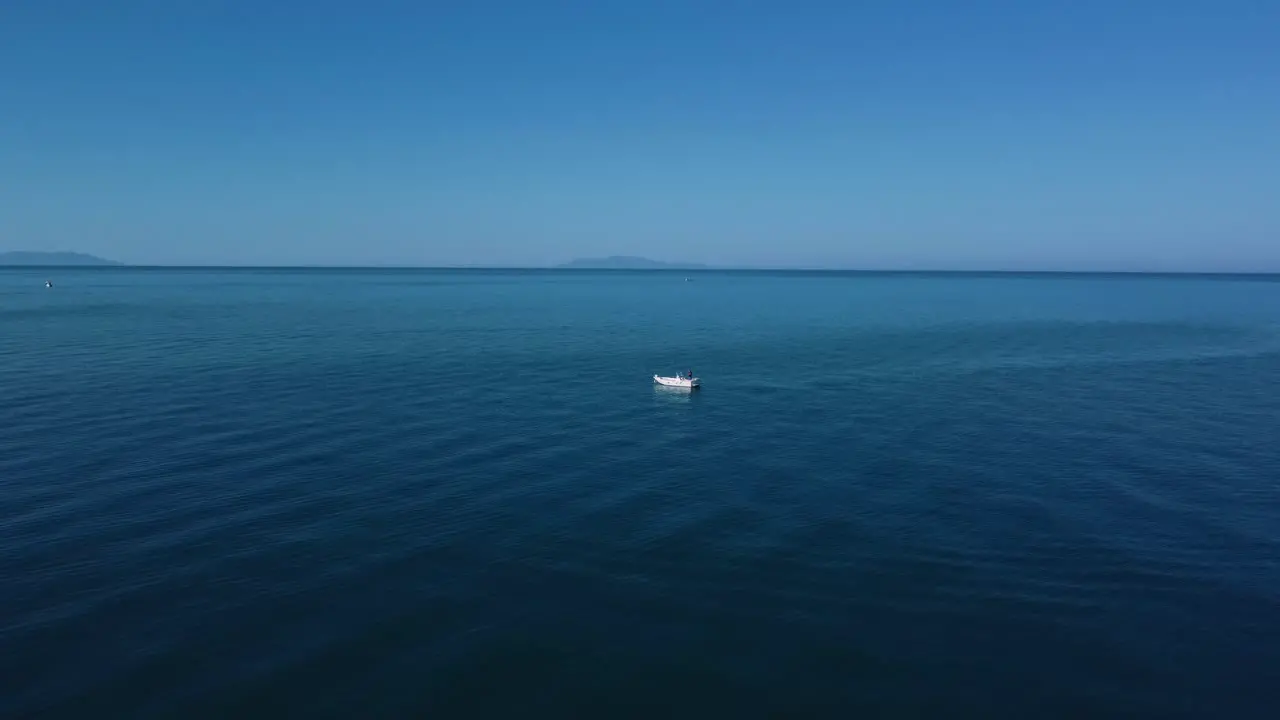 Drone over fishing boat in Tuscany Italy at a sandy beach at the seaside near Alberese in the iconic Maremma nature park by sunset