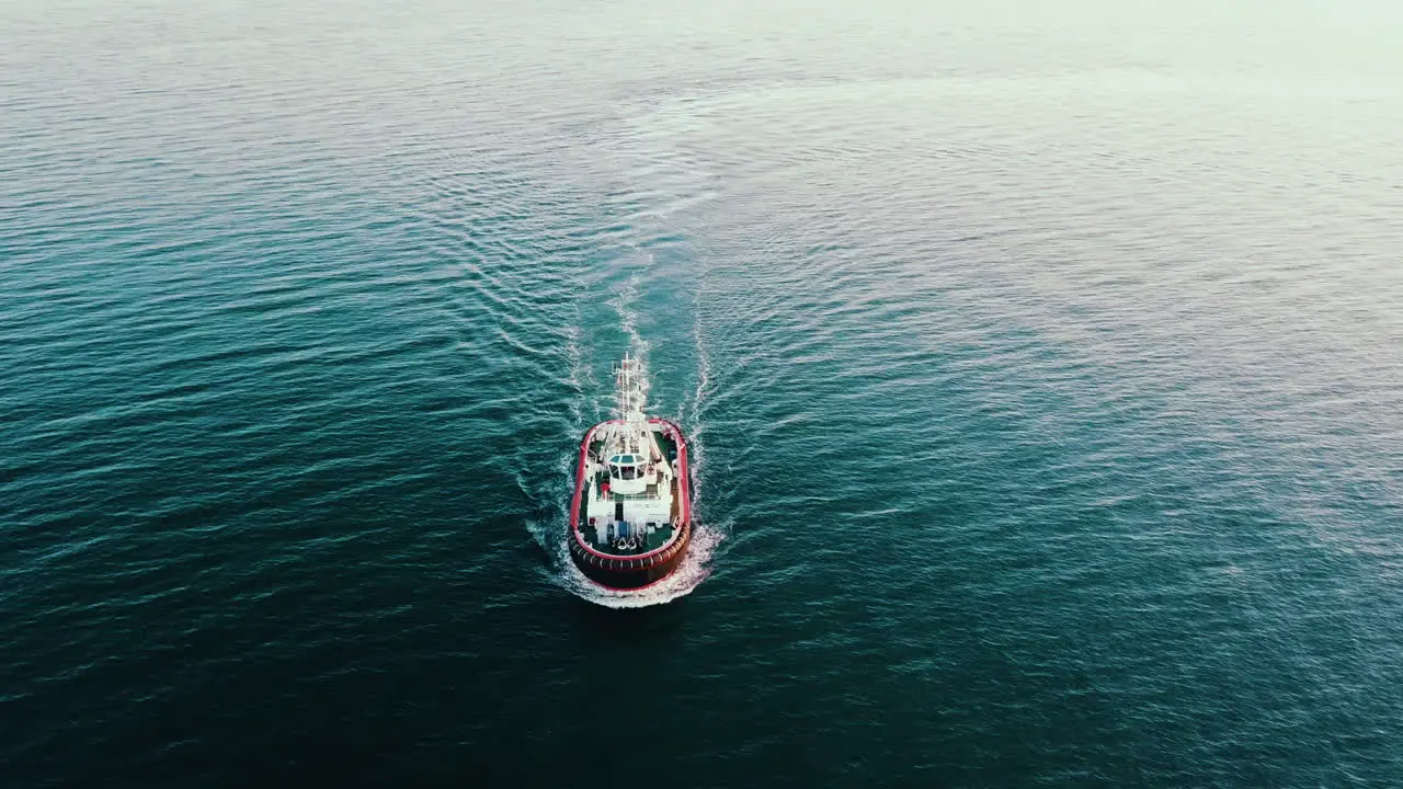 Drone flying over the fishing vessel sailing on the Baltic Sea at the sunset