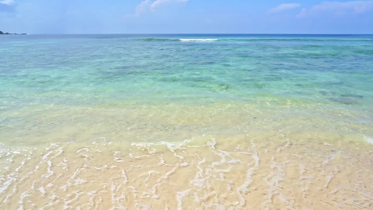 Waves wash over a pristine sandy beach